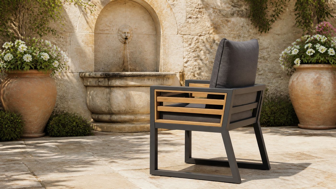 Garden armchair in a stone courtyard with a wall fountain