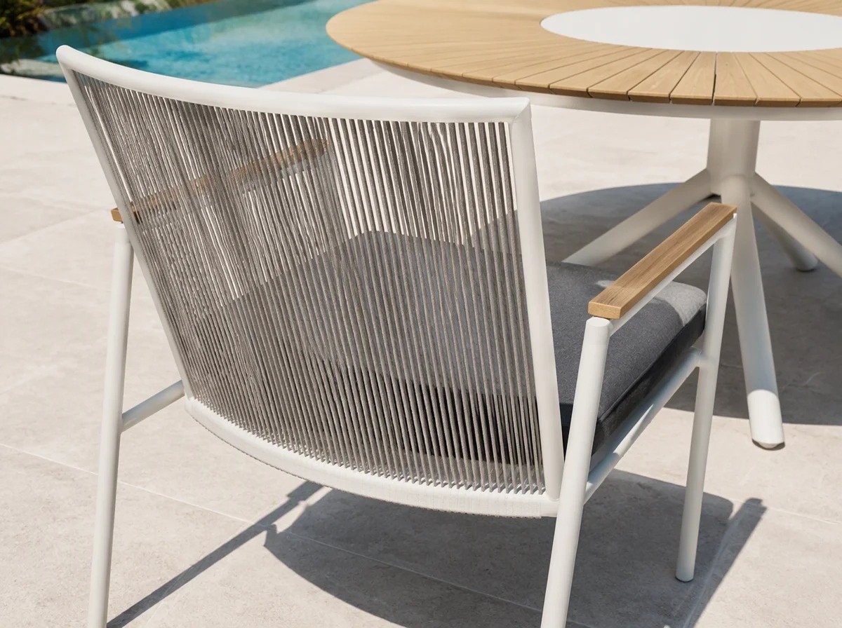 Close view of the tall rope back panel: thin vertical light grey strands between the curved white top rail and the seat