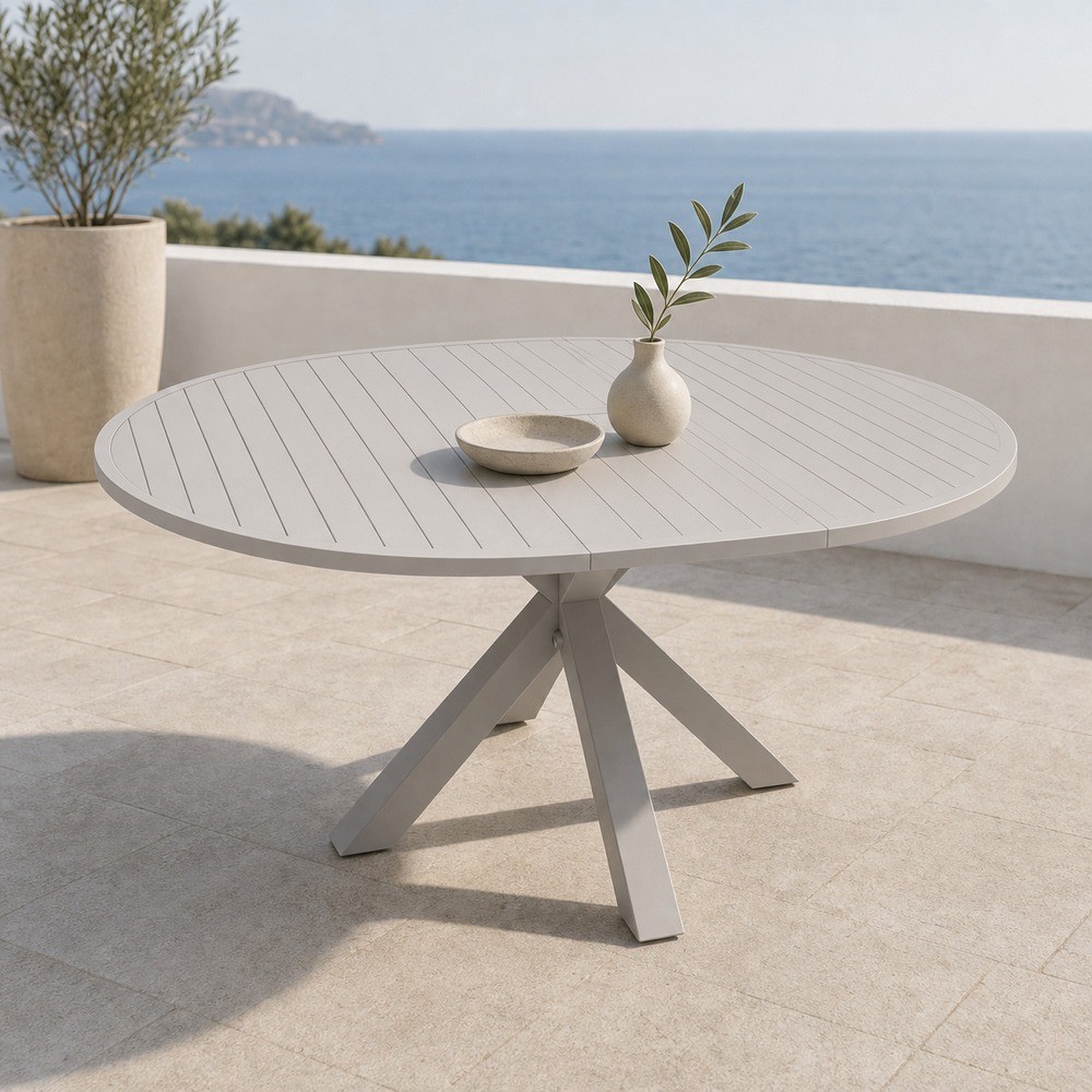 Round extendable aluminium slat table on a sea view terrace