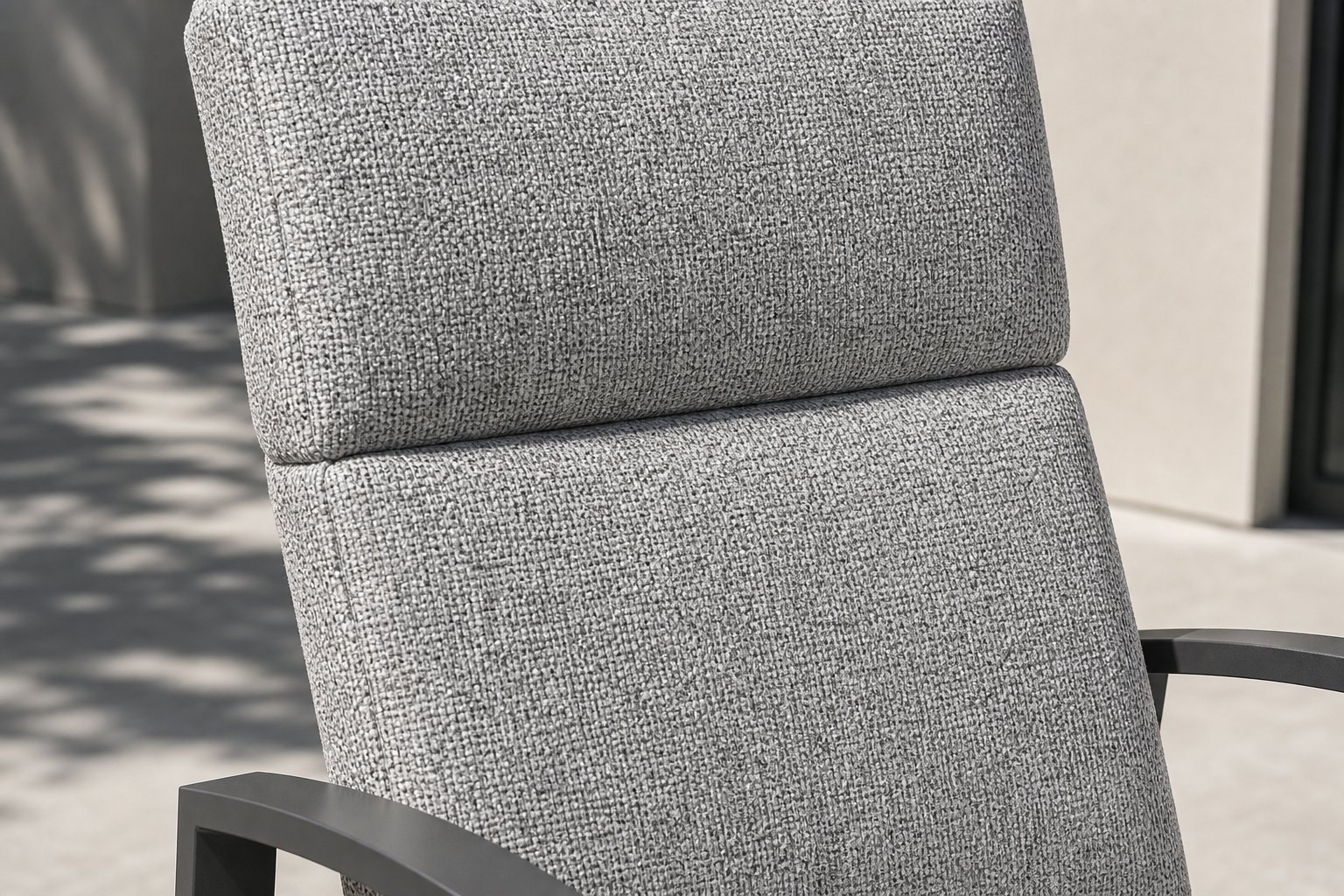 Close view of the two stacked back cushions of the high-back chair, showing the seam between the upper and lower pad