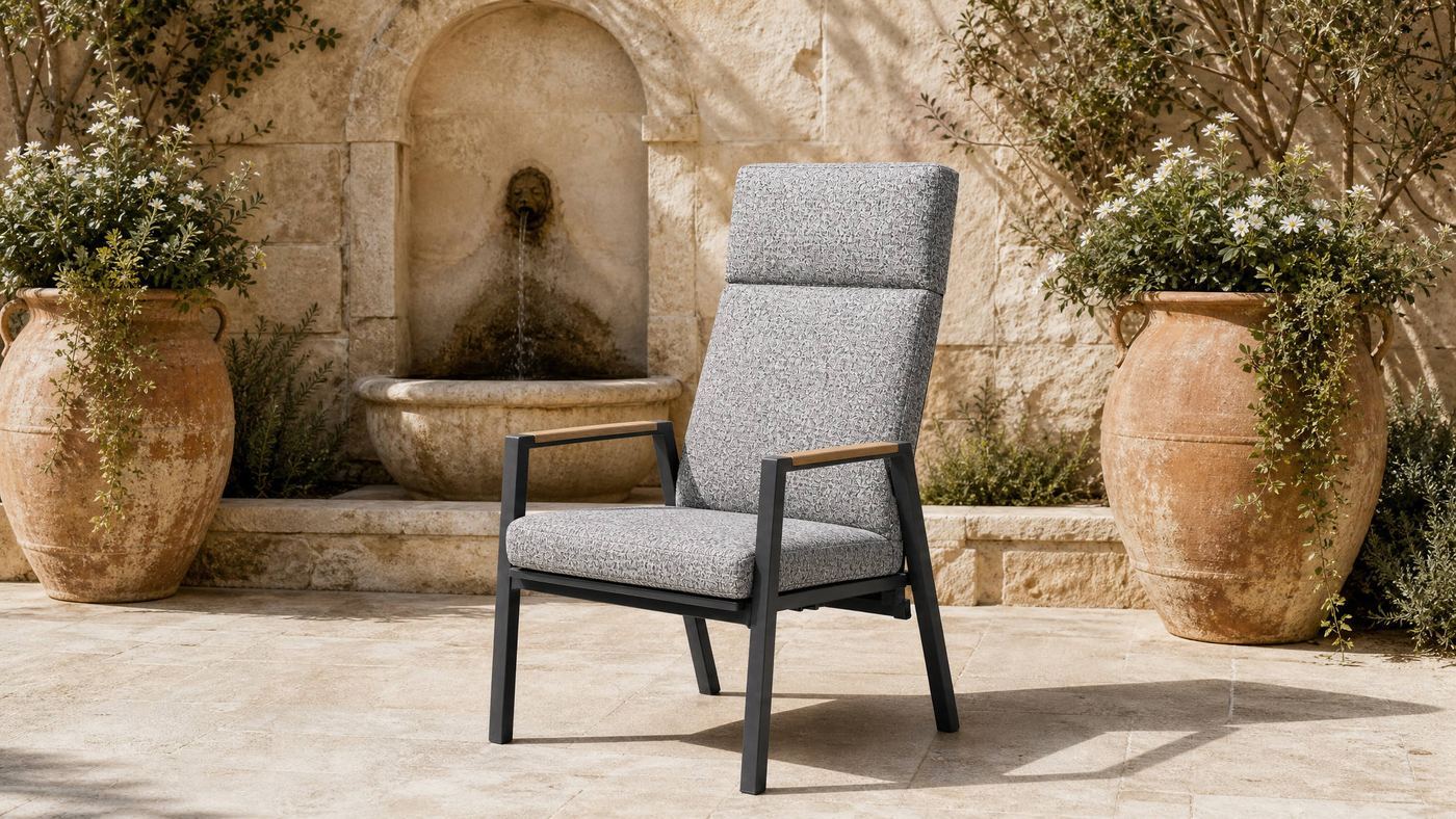 High-back armchair in a stone courtyard with a wall fountain