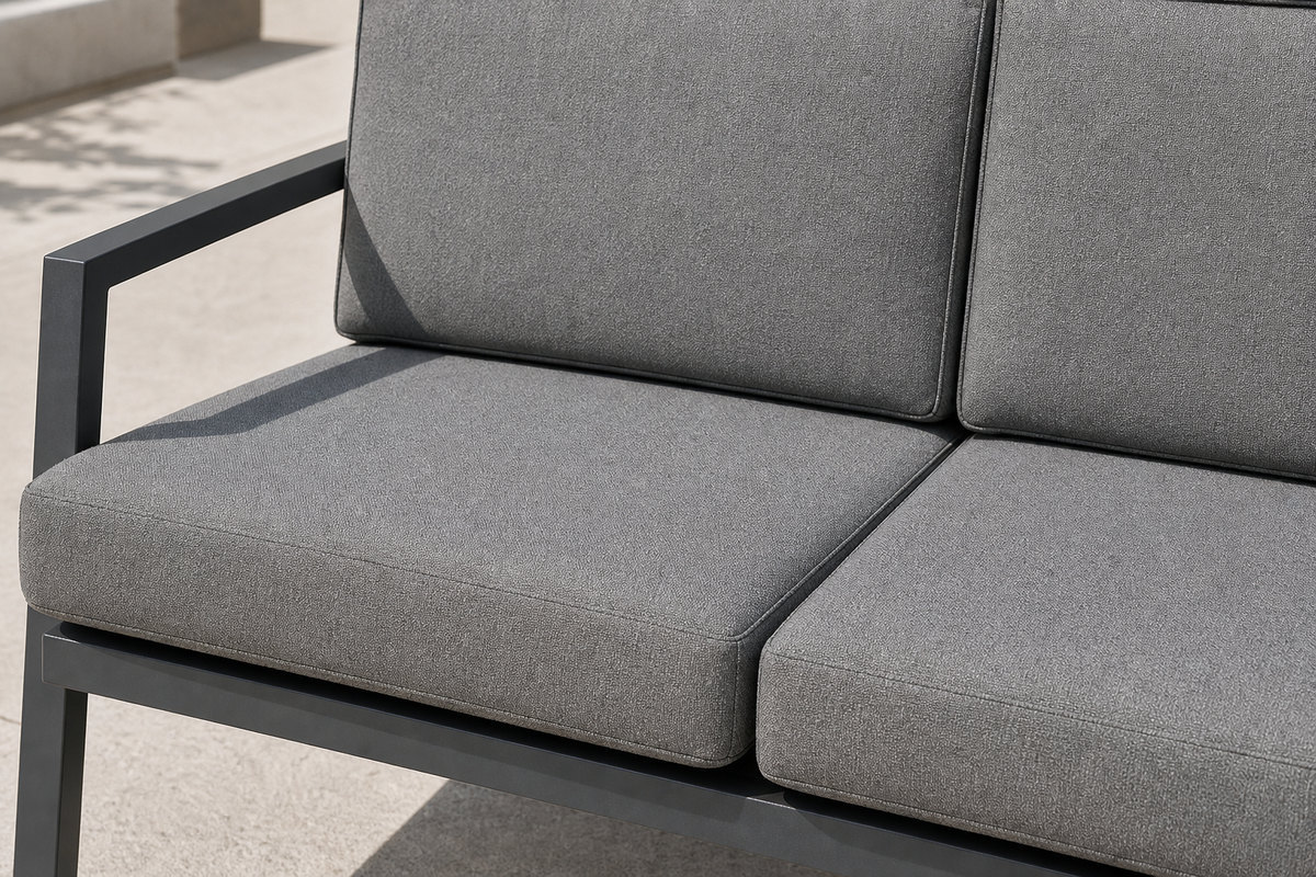 Grey woven quick-dry seat and back cushions on the charcoal aluminium frame of an outdoor sofa