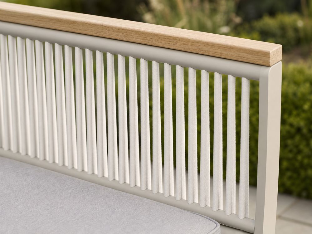Close-up of evenly spaced vertical rope strands woven into an outdoor chair side panel