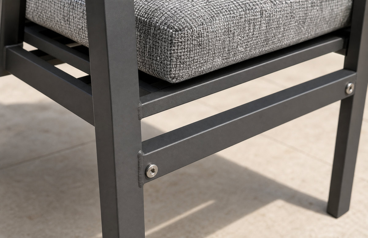 Close view of the welded square-section underframe of a contract outdoor chair with a lower brace and stainless fixings