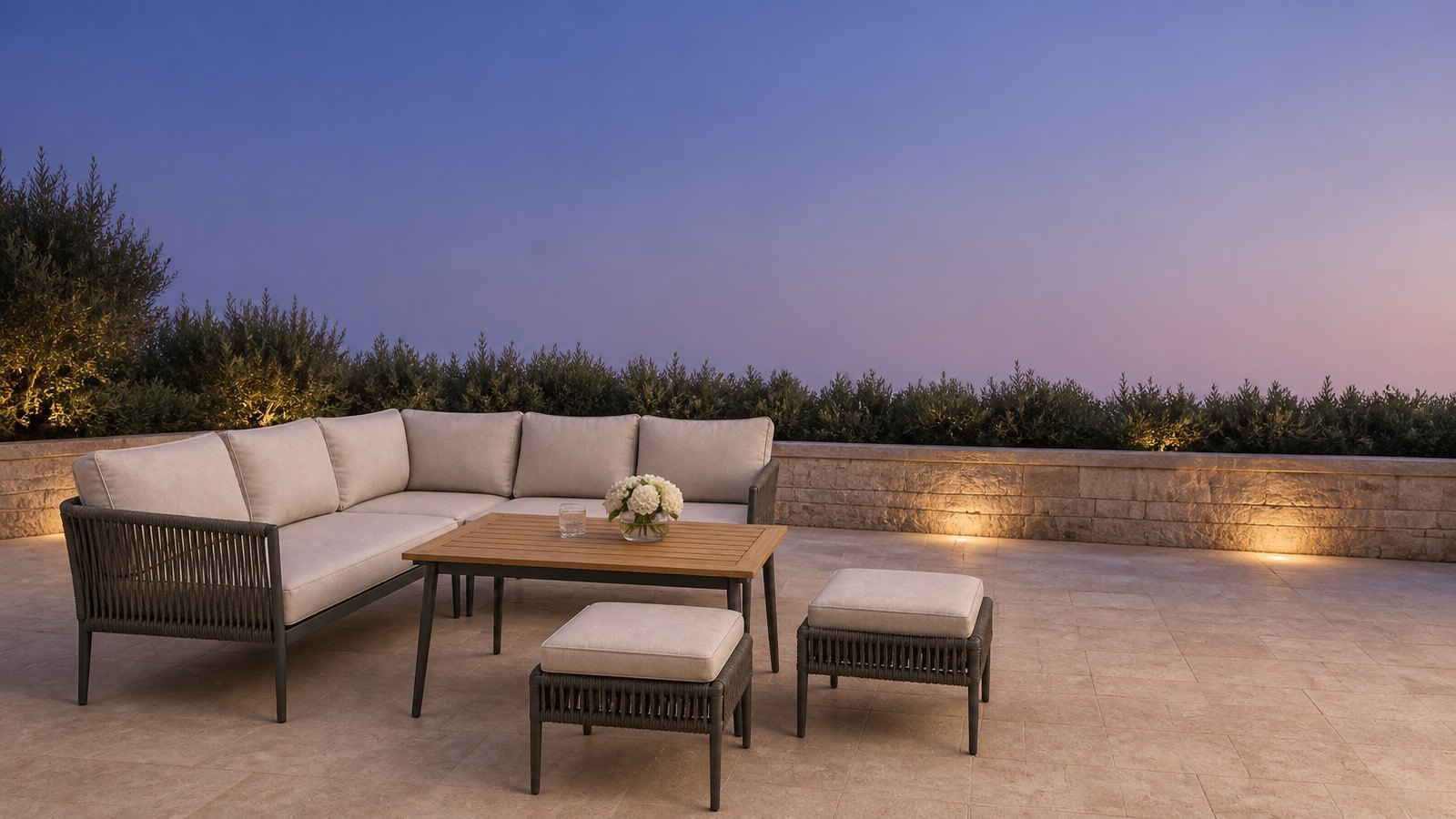 Aluminium outdoor sofa set on a stone villa terrace at dusk