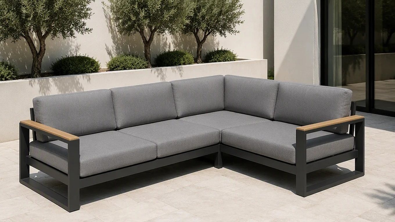 A six-piece outdoor corner lounge set with teak armrests on a terrace, with clipped olive trees behind