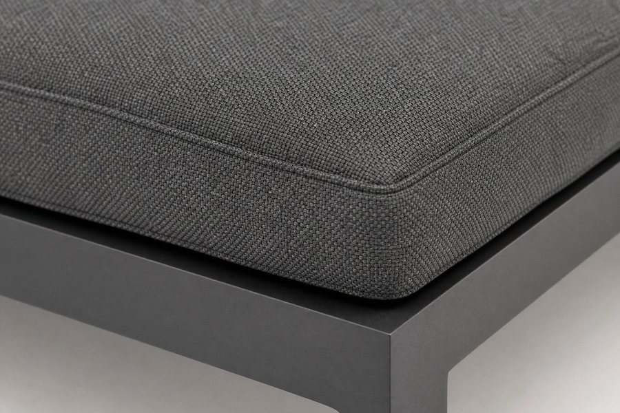 A close view of a grey cushion seam and the aluminium frame joint beneath it