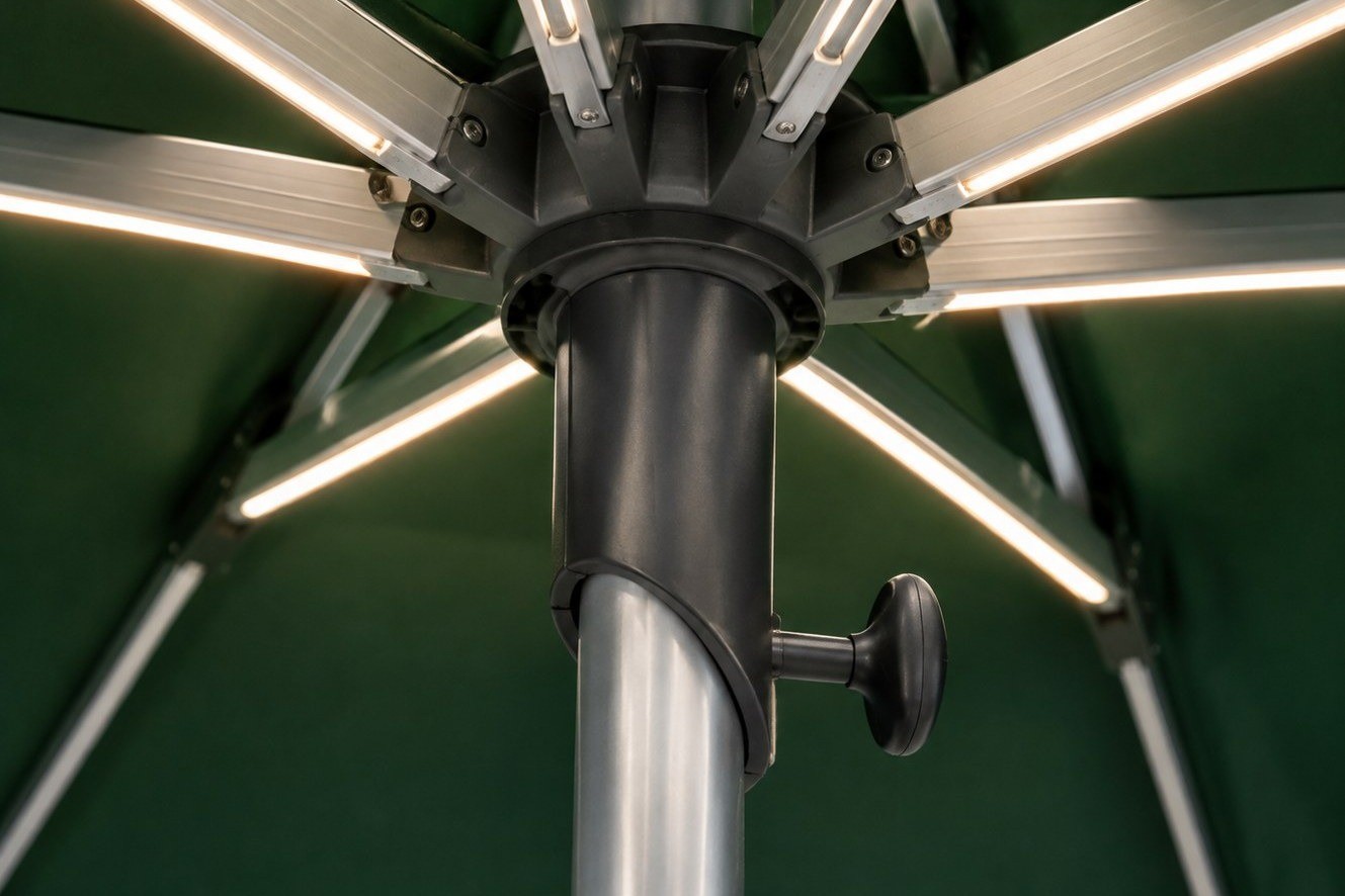 The die-cast hub of a commercial umbrella, with each aluminium rib bolted into its own socket beside the pole