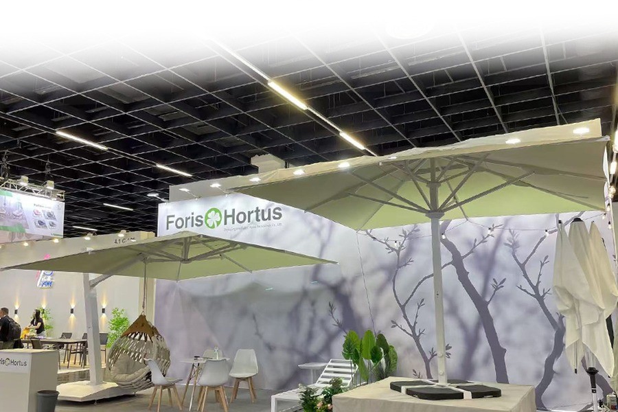 Foris Hortus exhibition stand in a trade-fair hall, with parasols and hanging chairs on display