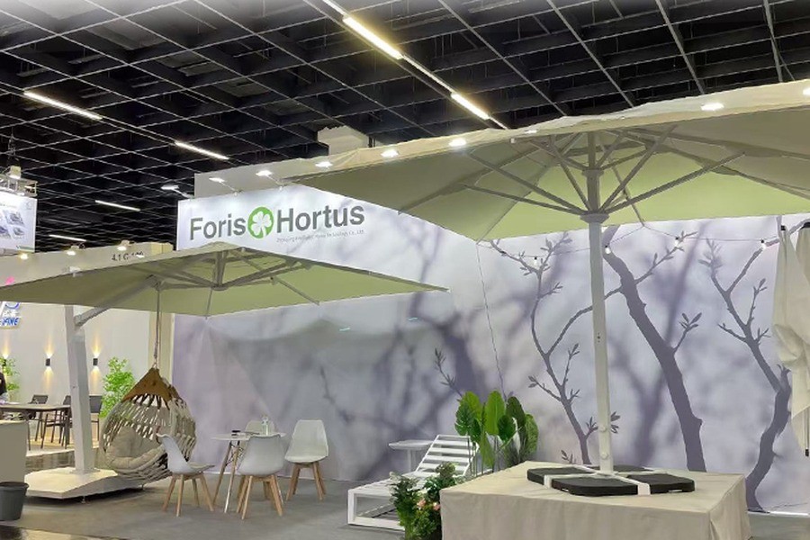 Outdoor furniture and shade products laid out on the Foris Hortus booth floor at a trade fair
