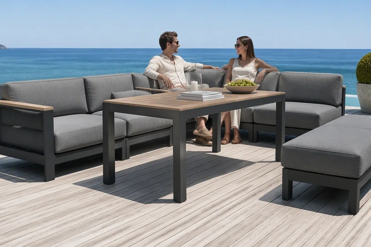 Grey cushion outdoor lounge set on a timber deck at the edge of the sea, showing an open layout exposed on the seaward side