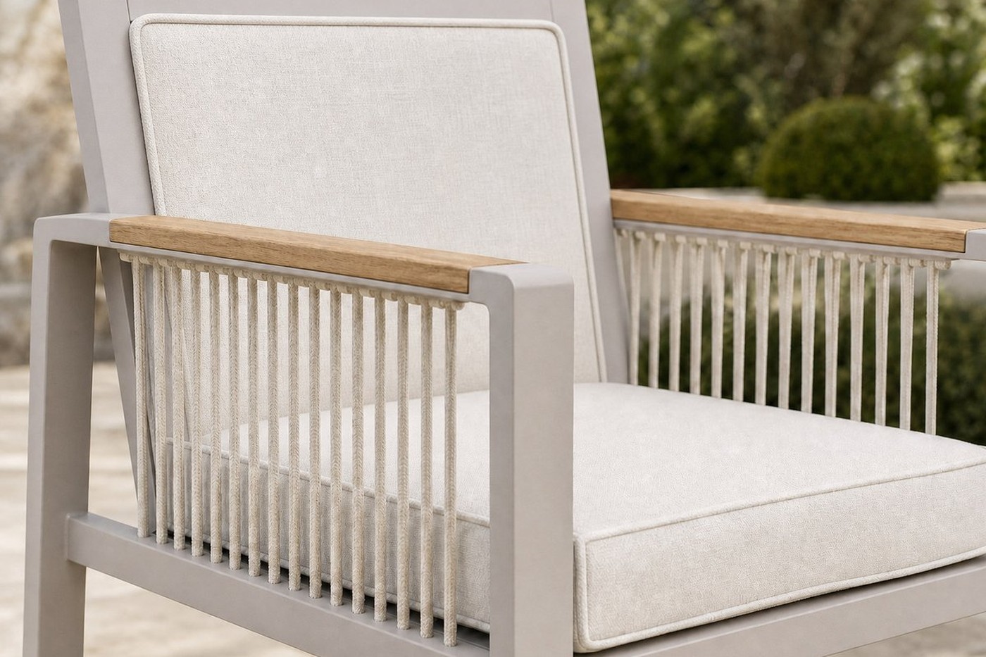 Rope weave outdoor lounge set with off-white seat and back cushions on a terrace, cushions finely piped along the edges