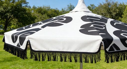 Custom-printed canopy with a customer logo on a commercial umbrella