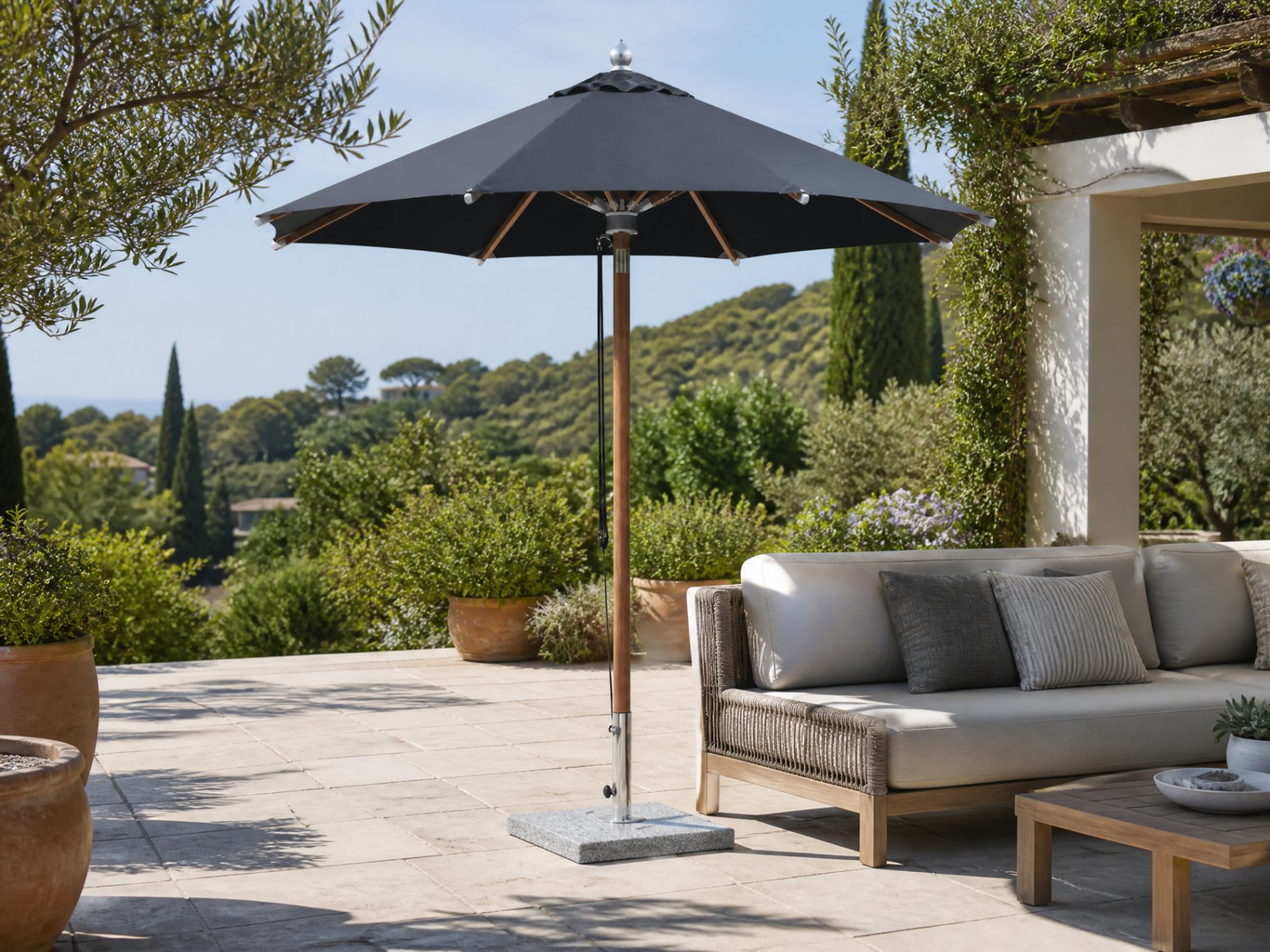 Center pole patio umbrella shading a villa courtyard dining setting