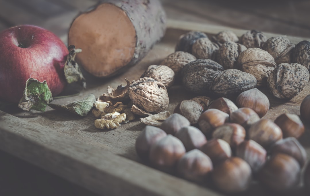 A vibrant image showcasing an assortment of fresh plant-based foods, with walnuts prominently featured