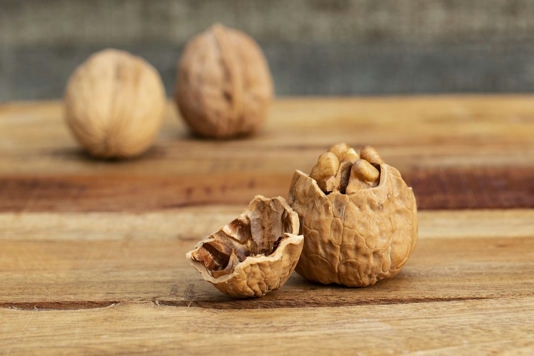 A visual comparison of different walnut kernel grades, from extra light halves to amber pieces