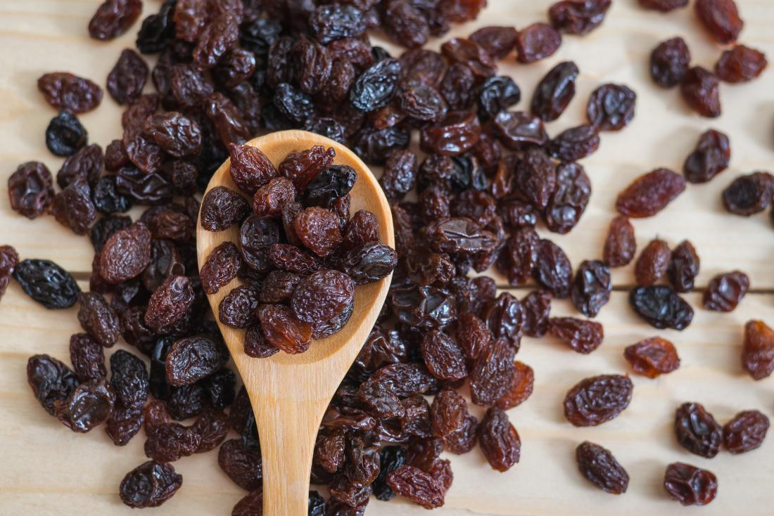 Dried fruits including raisins arranged in bowl for quality inspection