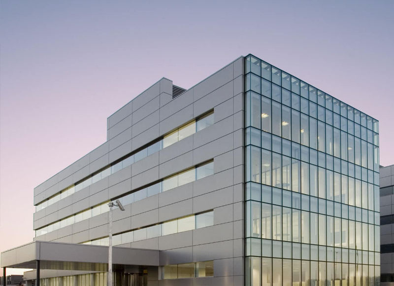 Modern building facade combining glass curtain wall and aluminium panels