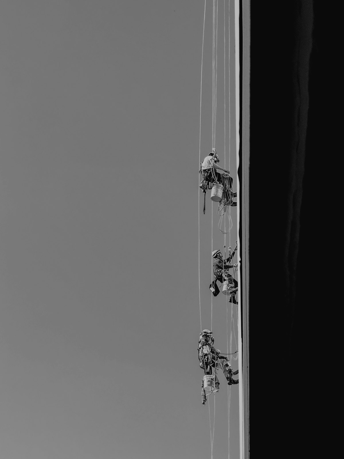 Rope access professionals using harness and connection equipment