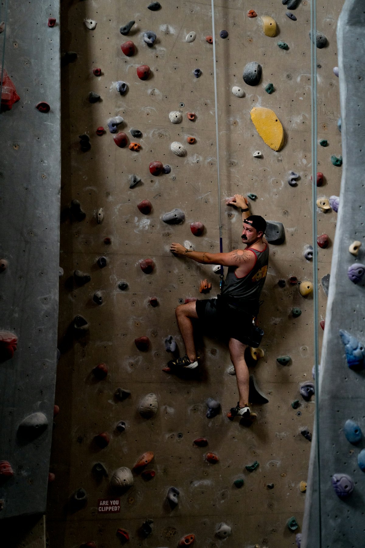 Climber using safety rope on a rock wall