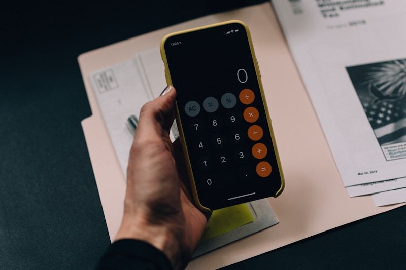 Business financial documents and calculator showing payment processing