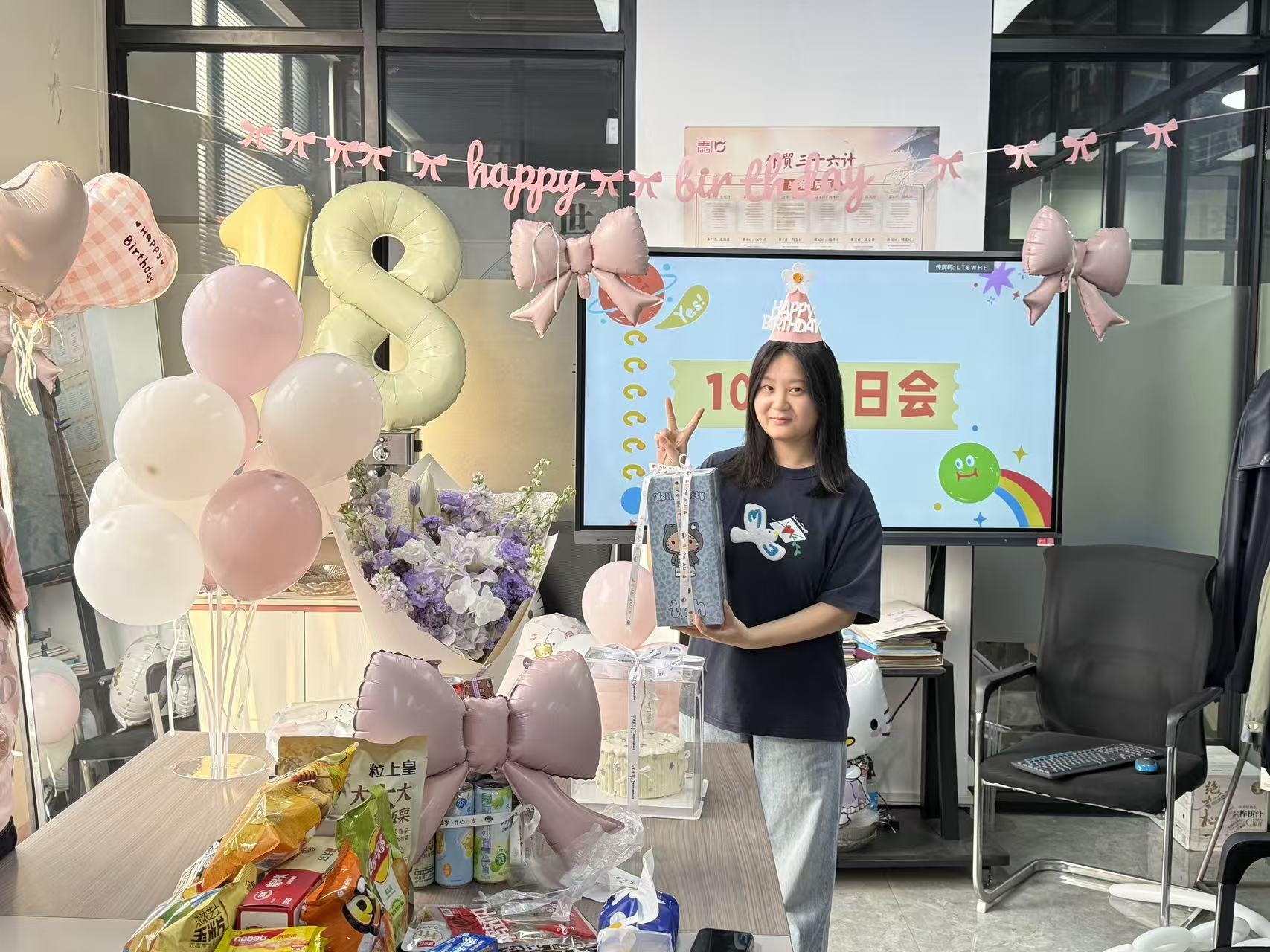 Vainnx team member holding a birthday gift during the office celebration