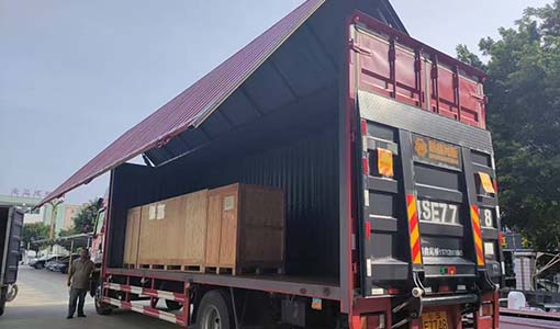 Samegram's checkweigher is being loaded onto a truck for shipment.