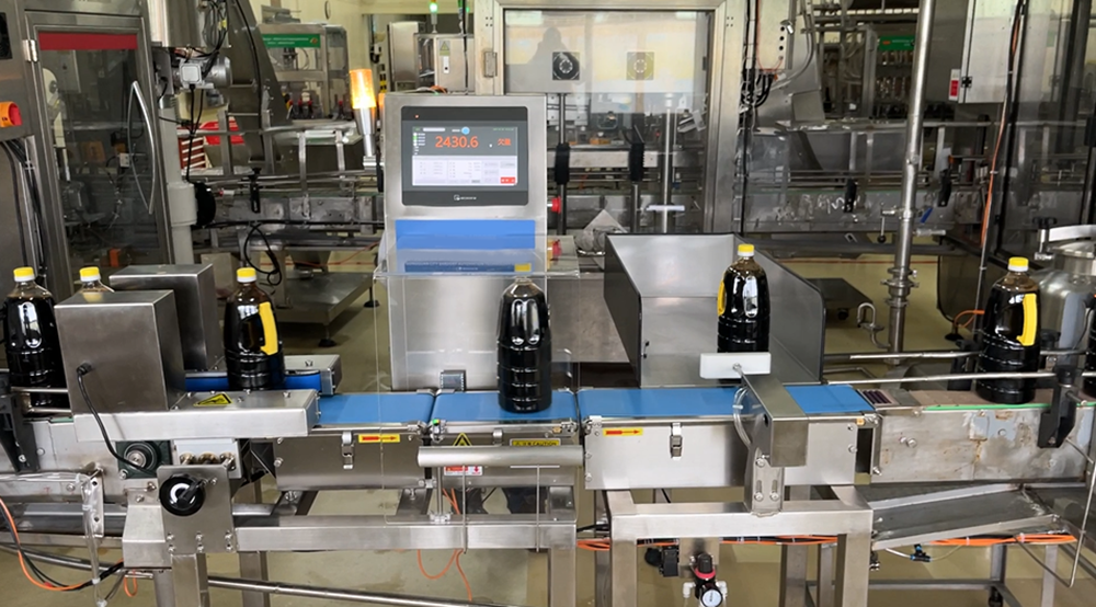 Dynamic checkweigher inspects large bottles of soy sauce