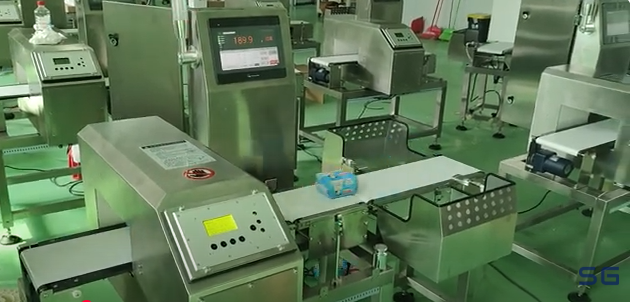 Conveyor metal detector identify potential foreign metal objects in sanitary napkins