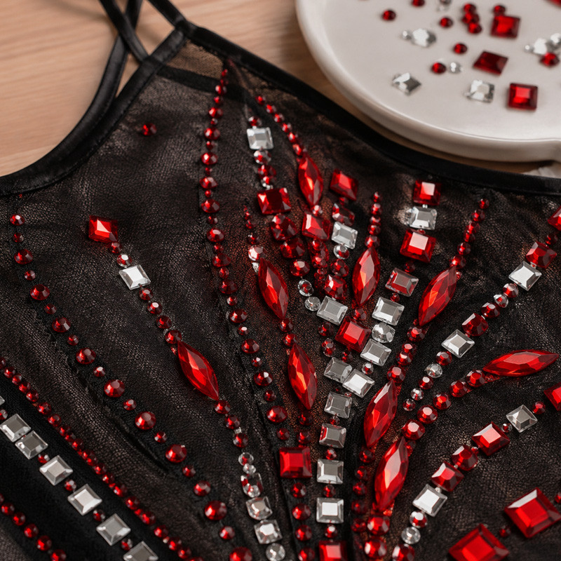 Single prong rhinestones incorporated into finished apparel
