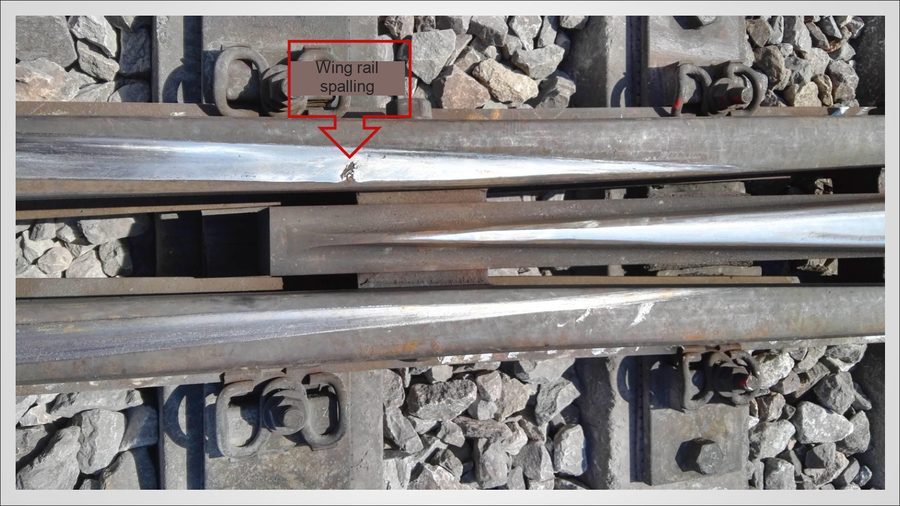 Wing rail spalling at a frog crossing before repair