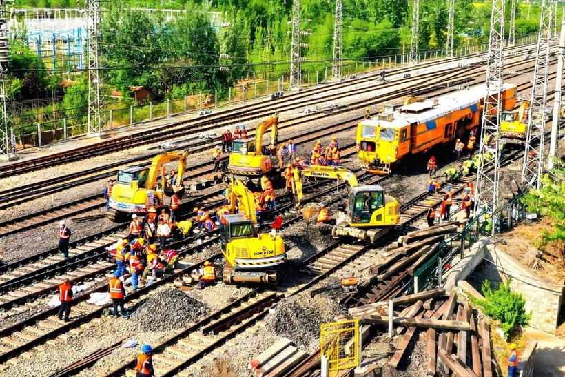 railroad track maintenance gang working on site with hand tools