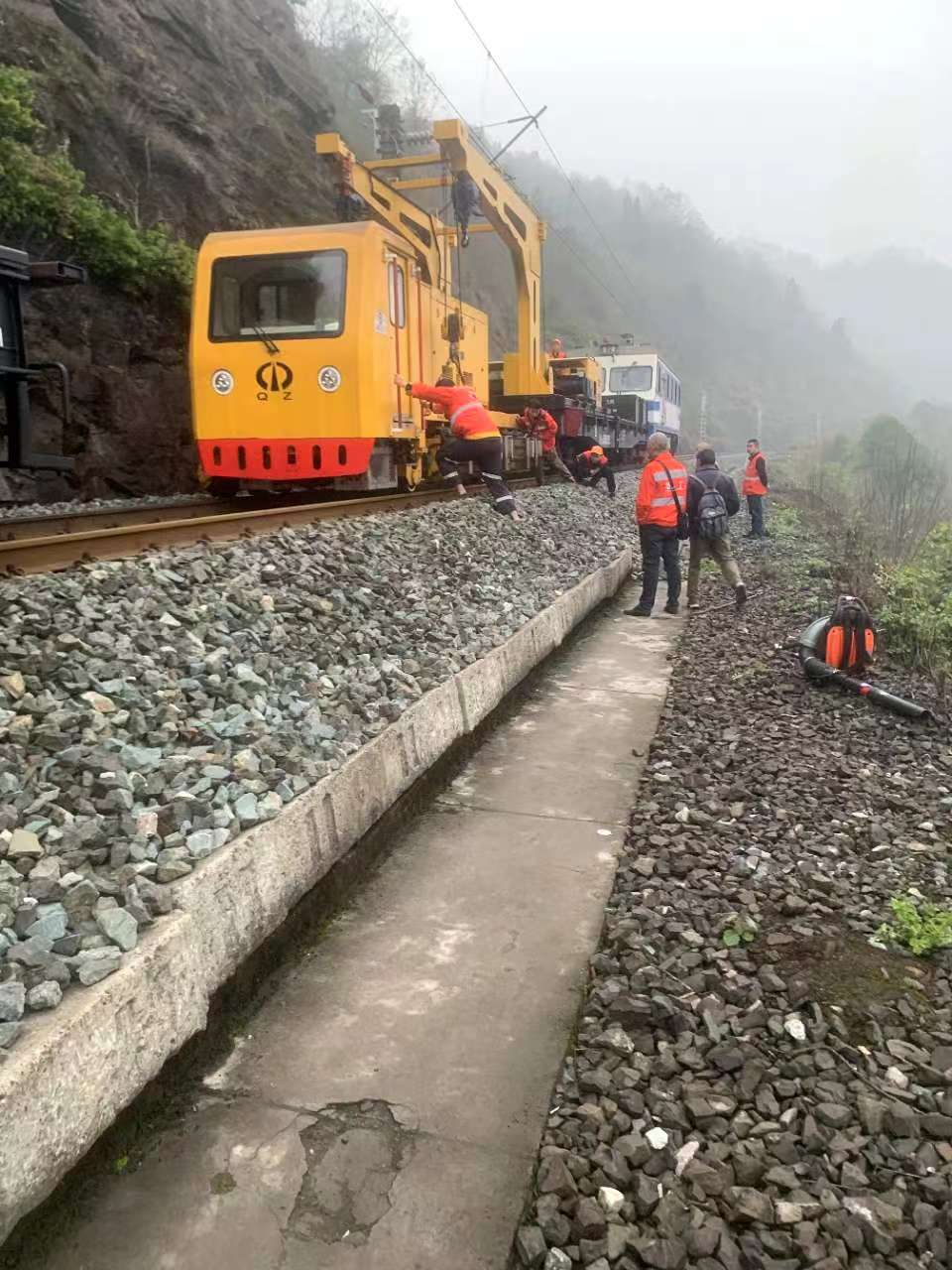 rail grinding machine and support equipment on track during a scheduled maintenance possession