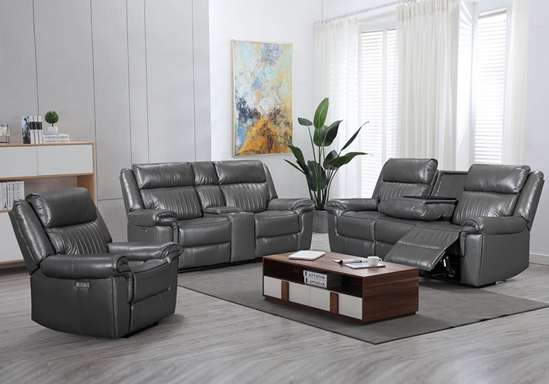 Grey sectional recliner sofa with a corner return and a side table in a bright living room with a plant