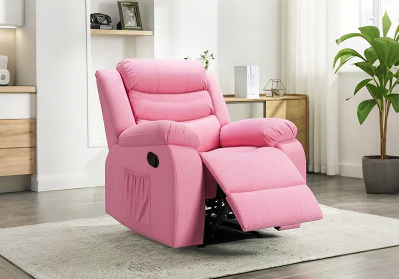 Pink kid recliner chair in a styled child's room with a rug and side cabinet