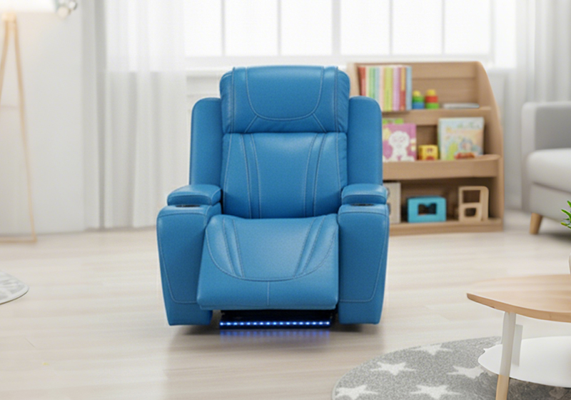 Blue kid recliner chair photographed in a child's room with bookshelves behind