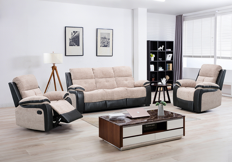 Pair of black leather recliner seats in front of a dark feature wall with a large window