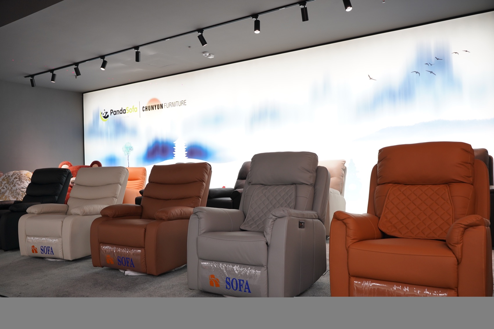 PandaSofa showroom brand wall with a row of leather and fabric recliner chairs