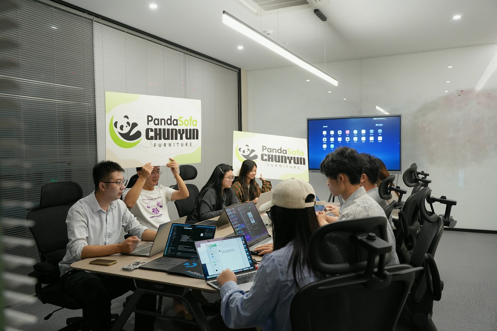 The PandaSofa meeting room with the company brand wall.