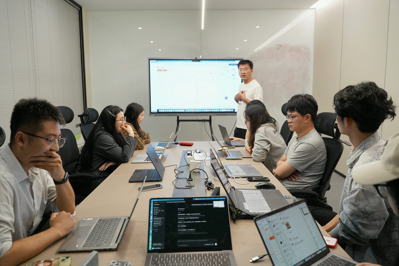 Colleagues presenting the automated short-video workflow to the team.