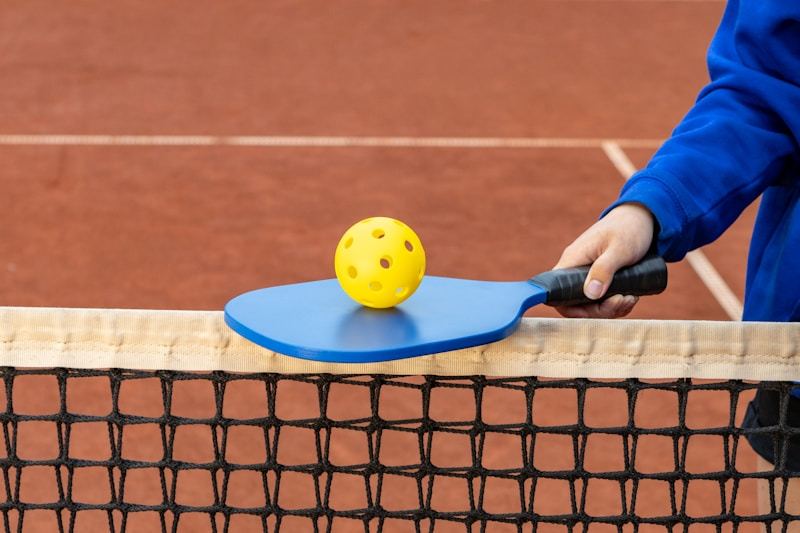 Pickleball player holding a racket on an outdoor court
