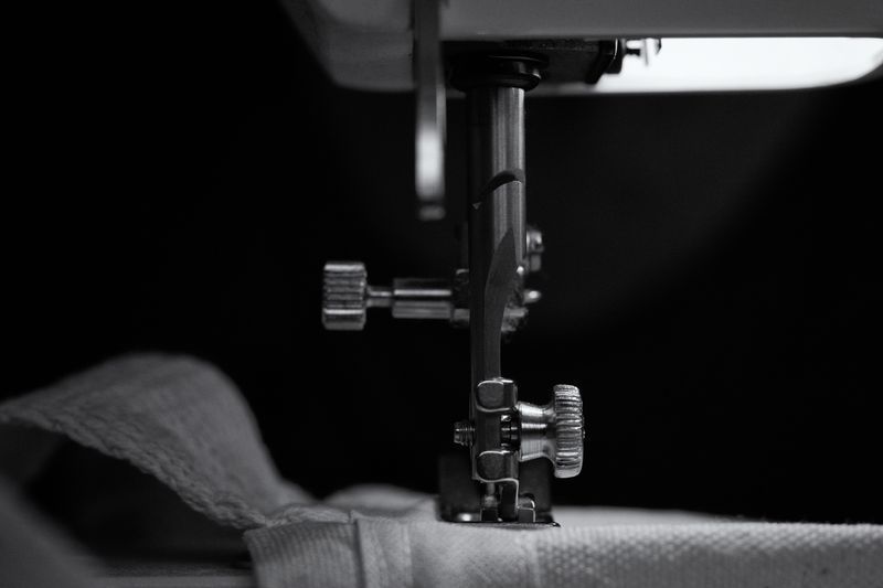 Worker operating industrial sewing equipment inside our activewear factory in Humen, Dongguan