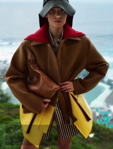LOEWE 180th anniversary campaign visual — shearling coat with sporty striped skirt
