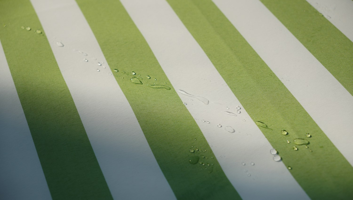 Water droplets beading on a water-repellent fabric surface
