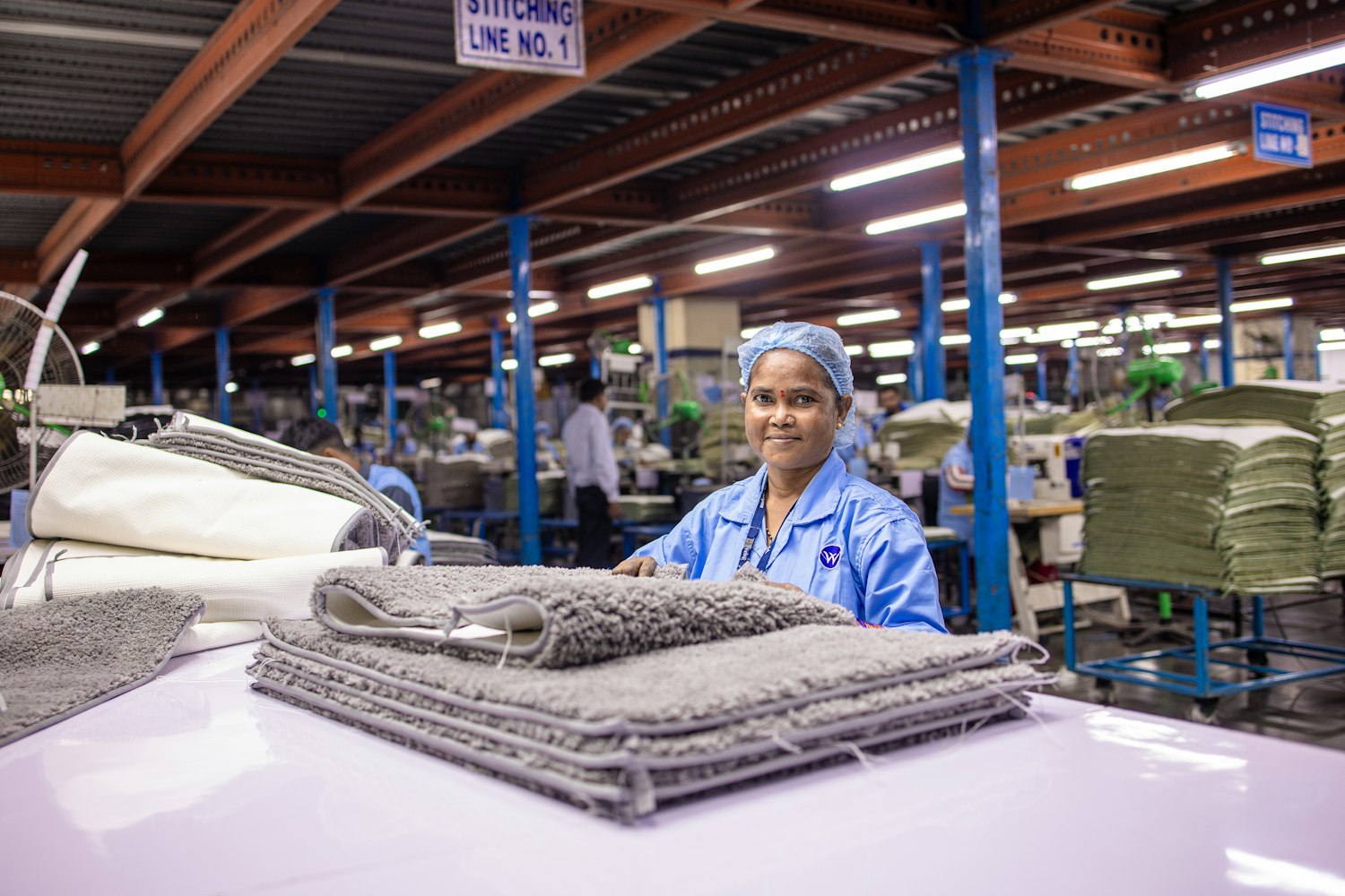 Factory worker smiling in a textile sewing floor