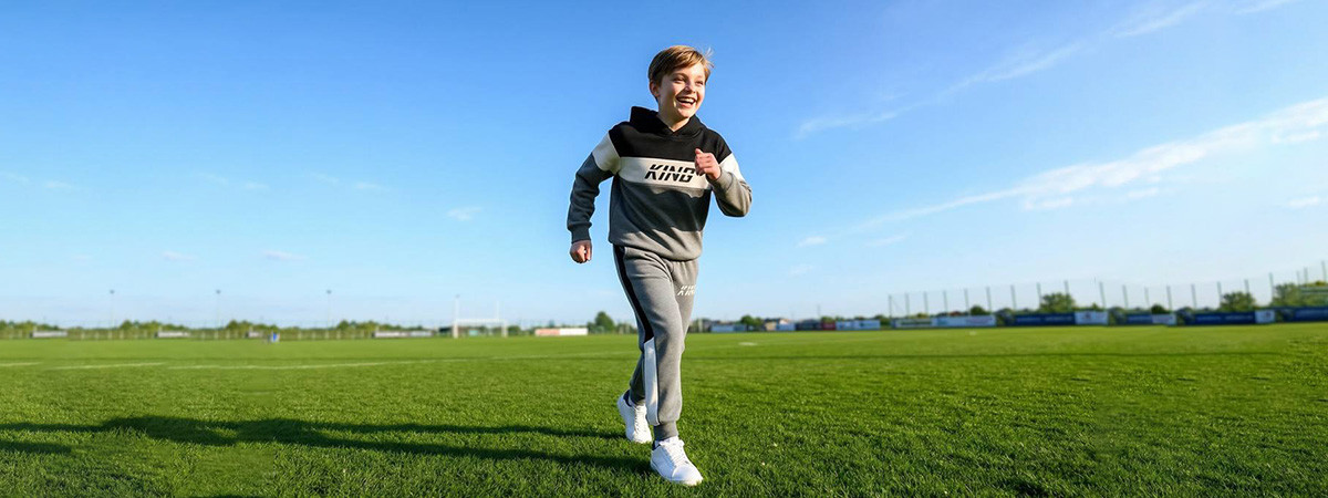 Happy kids in colorful custom sportswear on a sunny field