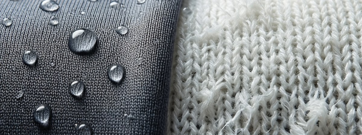 Polyester and cotton athletic t-shirt fabric compared side by side with moisture beading on the synthetic knit