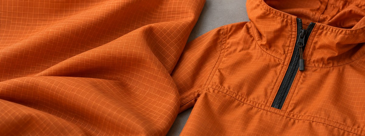 Ochre ripstop anorak fabric grid and half-zip construction detail