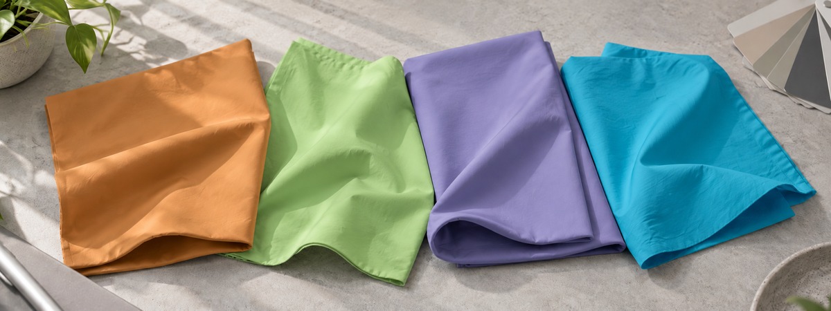 Tan, lime, lavender and turquoise woven fabric swatches with a color fan
