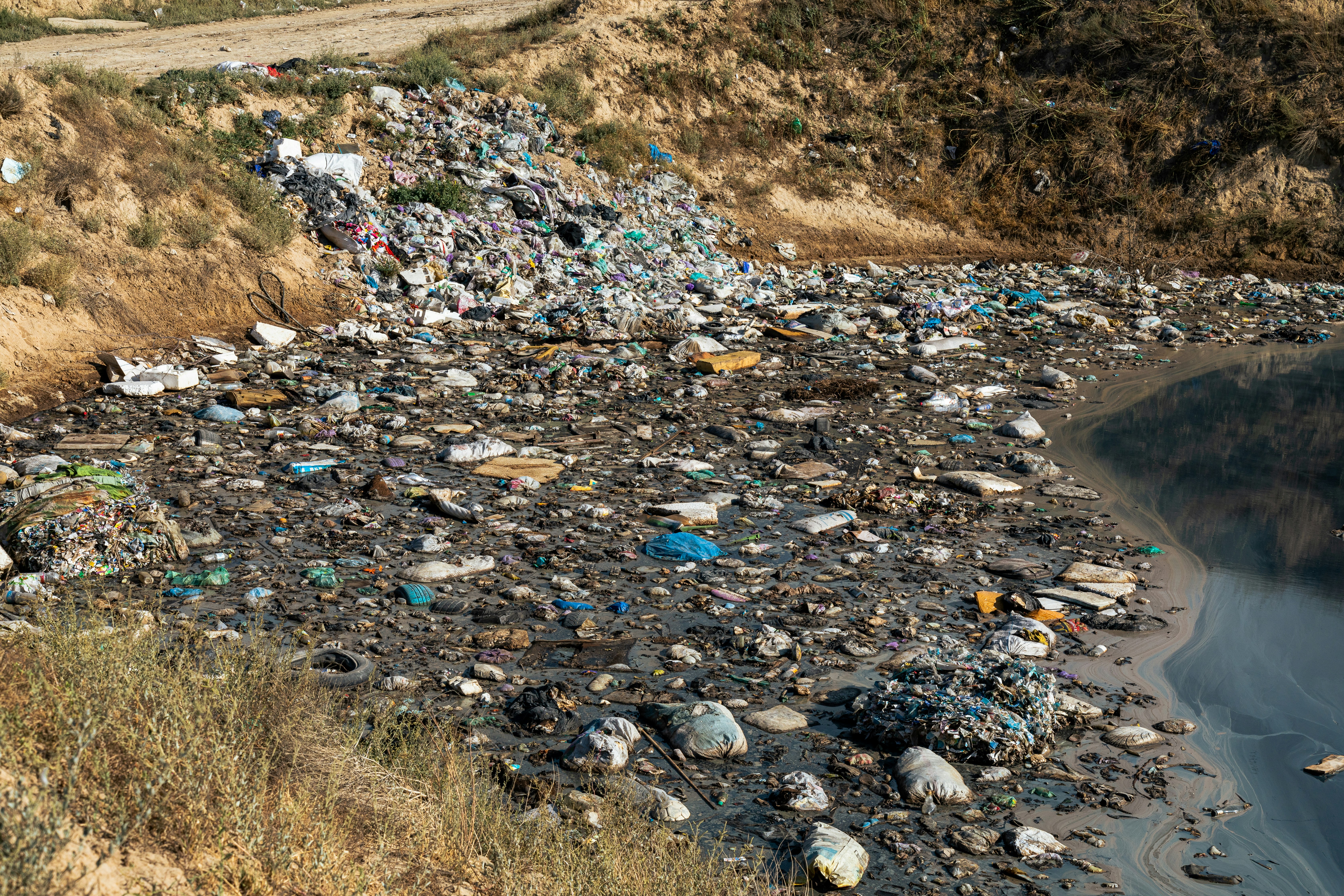 Textile waste in a landfill, highlighting the recycling problem